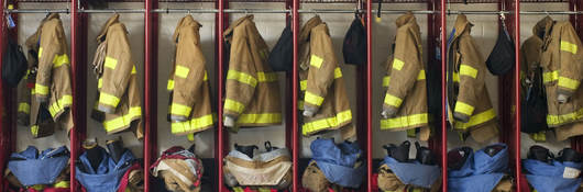 Firefighter suits hung in a row