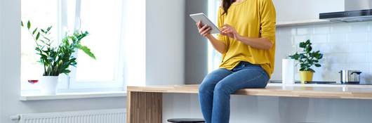 Women sitting on counter with tablet