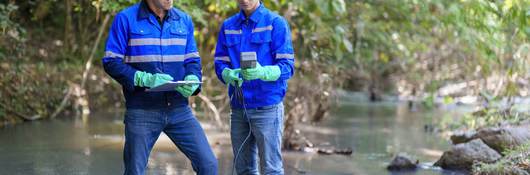 Environmentalists taking water samples in a creek