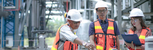 Pipeline oil engineers having a discussion in a factory