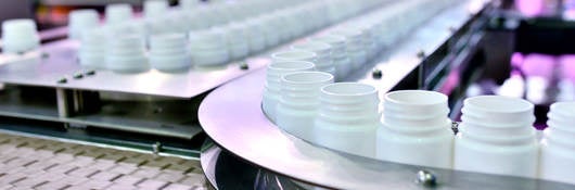 White plastic bottles on a production line