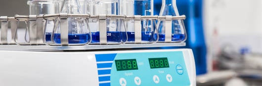 Close-Up Of Beakers On Weight Scale In Laboratory