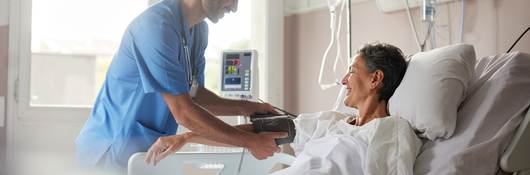 Nurse taking pulse of patient.