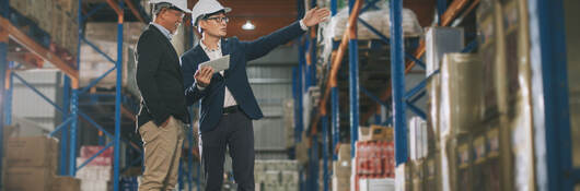 Two managers touring a warehouse