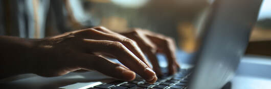 A person typing on a laptop