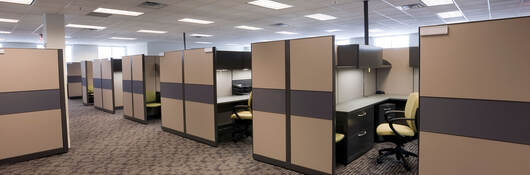 Several vacant cubicles in an office building