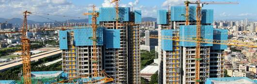 Cranes working on the construction of two skyscrapers