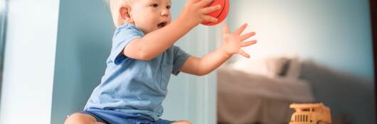 Baby boy playing with toys.