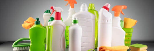 several cleaning products on a gray background