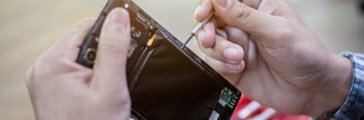 Man repairing a mobile phone.