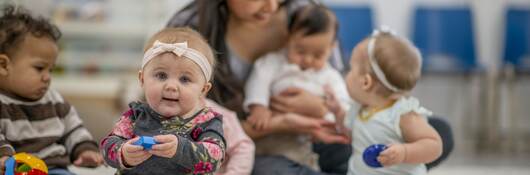 Childcare worker with babies.