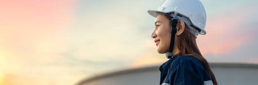 Petroleum oil refinery engineer worker with personal safety equipment PPE to inspection follow checklist by tablet