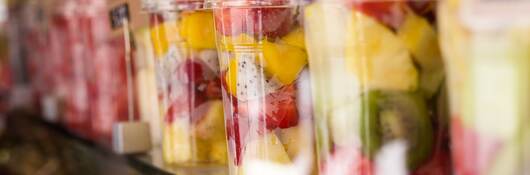 Fresh colorful fruit salad in plastic packaging.