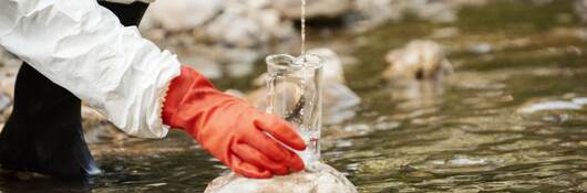 Scientist examining toxic water samples.