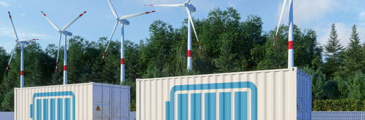 Energy storage systems with wind turbines in background