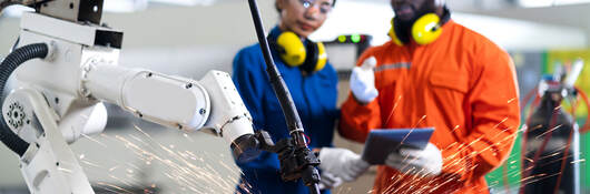 People wearing PPE and working with machinery