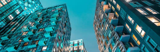 A glass skyrise with beautiful sky