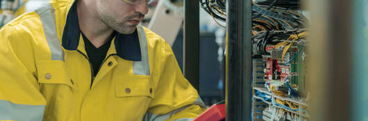 A worker using a voltage meter