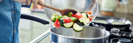 A person cooking colorful vegetables