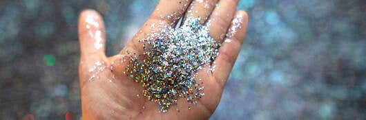 A hand with glitter in the palm