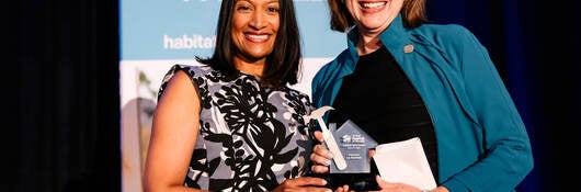 Jennifer Scanlon, president and CEO of UL Solutions (right), accepts the 2025 Habitat Hero Award on behalf of UL Solutions and poses with Meena Beyers, vice president of business and community development at Nicor Gas, during a June 12 event in Chicago.