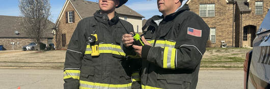 Two firefighters talking