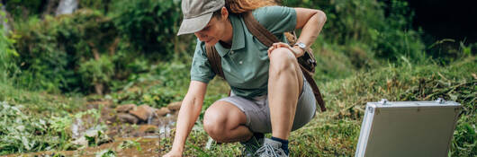 Biological Researcher Taking a Water Sample