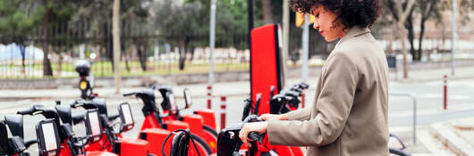 Person renting an e-bike near a park