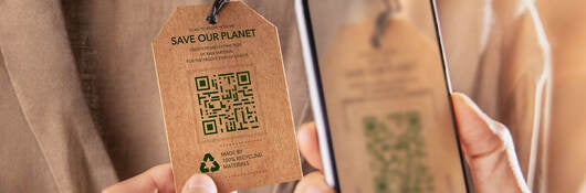A person checking a clothing tag QR code