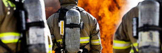 Three firefighters putting out an house fire