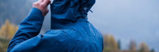 Runner adjusting weather proof clothing and rain jacket 