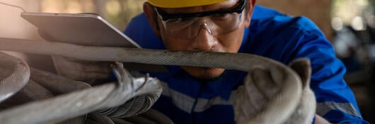 Engineer inspecting a wire cable