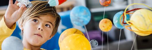 A child playing with a constellation toy