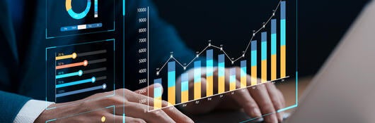 photo of hands typing on laptop with futuristic virtual graph ui on top