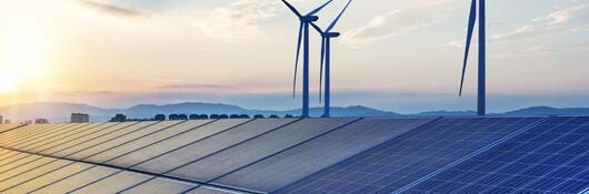 windmills and solar panels in a beautiful sunrise