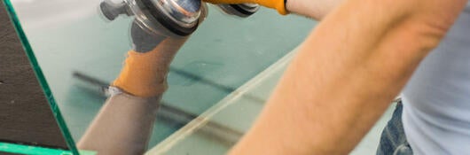 Person moving a heavy pane of glass
