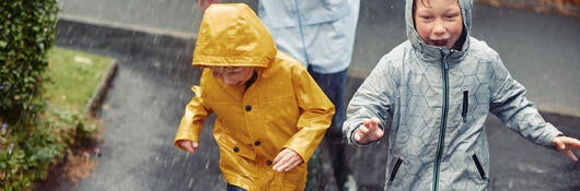 A family running in the rain