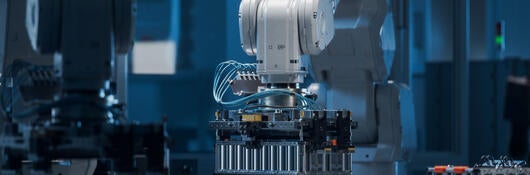 A robotic arm working on a battery