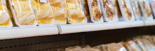 Prepackaged food on refrigerated grocery shelves