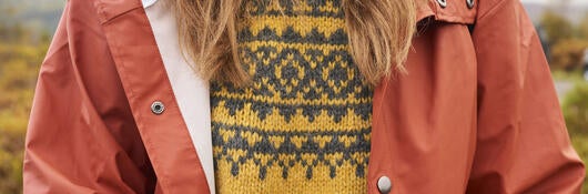 Detail of person's sweater and waterproof jacket