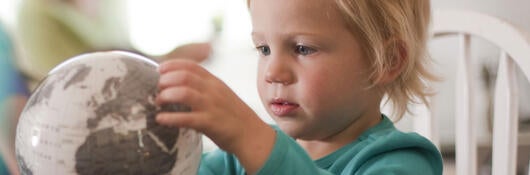 A child looking at a globe
