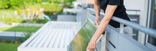 Woman installs plug-in solar panel on her balcony