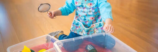A child playing with water beads