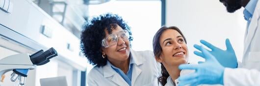 Three laboratory technicians discussing work