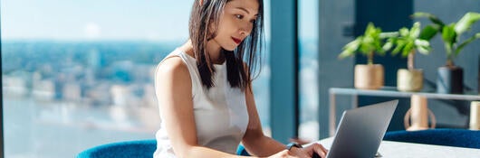 Person typing on laptop computer.