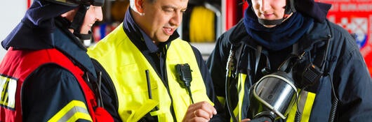 Firefighters looking at tablet.