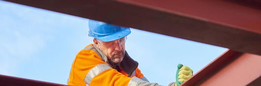 A steel worker and steel beams