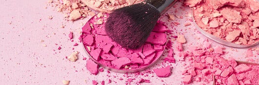 Make up brush with brush stroke of colored make up powder