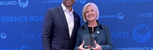 Alex Dadakis, executive vice president and president of Testing, Inspection and Certification at UL Solutions, and Linda Chapin, executive vice president and chief human resources officer, pose with the People First Excellence Award, presented by The Conference Board on June 3 in Chicago.
