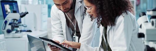 Science, teamwork and scientist with tablet in laboratory for communication, pharmaceutical review or planning. Employees, collaboration and technology for research, discussion and digital analysis